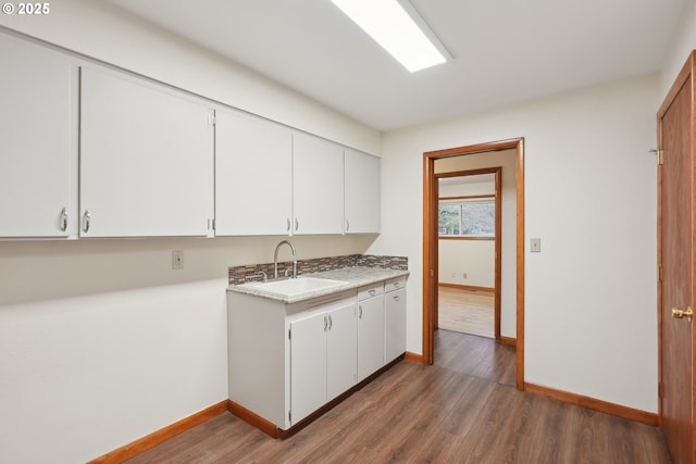 kitchen with white cabinetry, sink, and dark hardwood / wood-style flooring