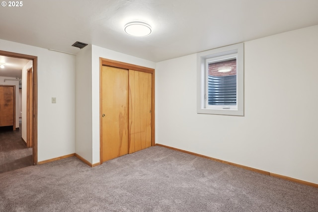 unfurnished bedroom featuring a closet and carpet flooring