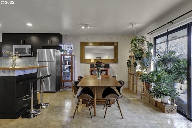 dining area featuring finished concrete floors