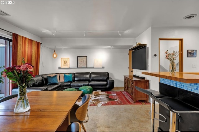 living room with visible vents and track lighting