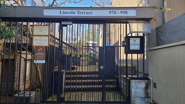 view of gate featuring central AC and fence