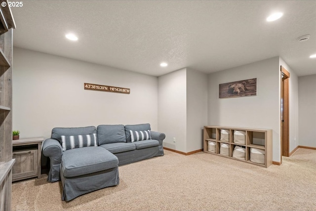 living area with baseboards, a textured ceiling, light colored carpet, and recessed lighting