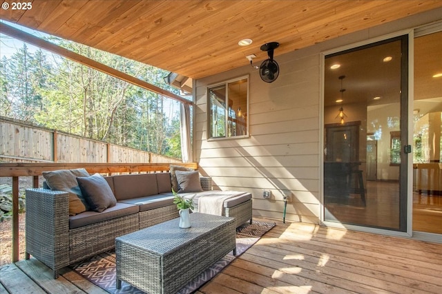 wooden deck with outdoor lounge area and fence