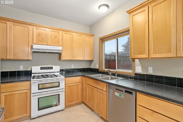 kitchen featuring dishwasher, double oven range, dark countertops, and under cabinet range hood