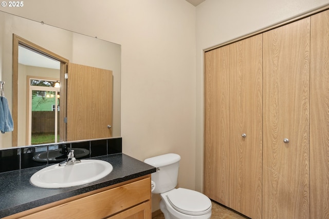 half bathroom with toilet and vanity