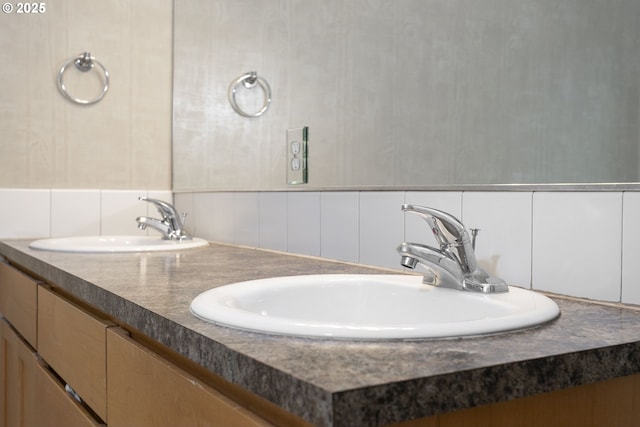 full bath featuring double vanity and a sink