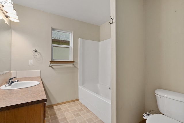 full bathroom with washtub / shower combination, vanity, toilet, and baseboards