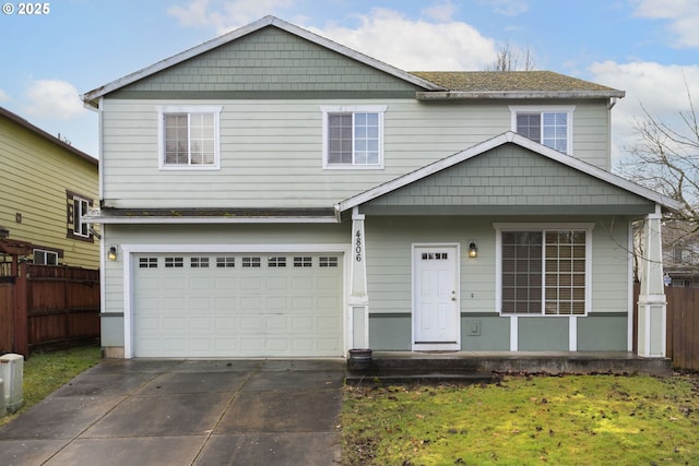 view of front of home with a garage, fence, concrete driveway, and a front yard