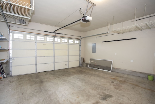 garage with a garage door opener and electric panel