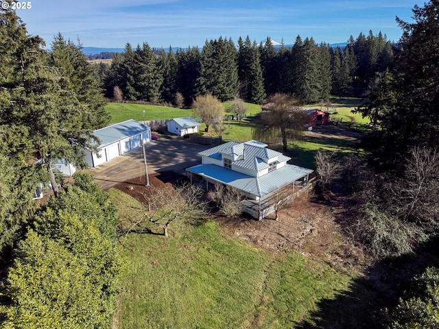 drone / aerial view featuring a forest view