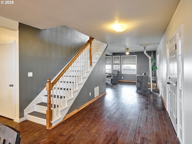 23860 S Beavercreek Rd, Beavercreek, OR 97004 - stairs featuring a wood stove, ceiling fan, wood finished floors, and a textured ceiling