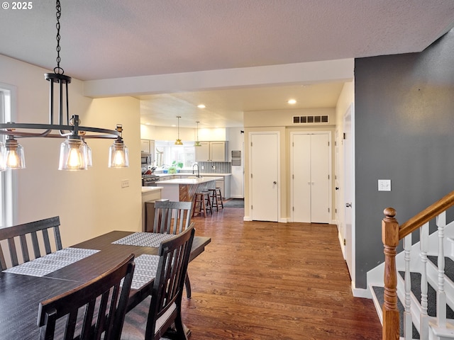 dining area with baseboards, visible vents, dark wood-type flooring, stairs, and recessed lighting