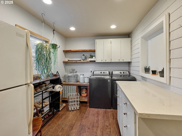 clothes washing area with cabinet space, recessed lighting, dark wood finished floors, and washing machine and clothes dryer