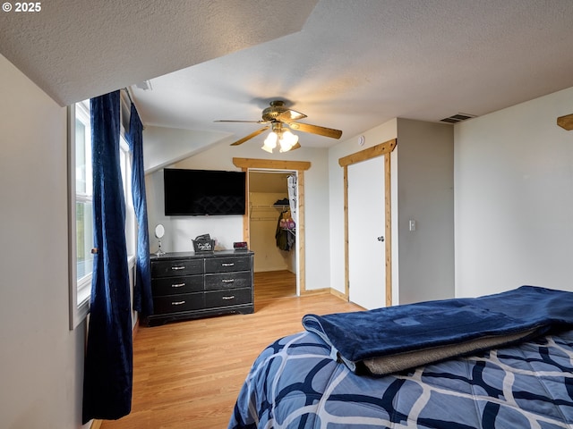 23860 S Beavercreek Rd, Beavercreek, OR 97004 - bedroom with a textured ceiling, light wood finished floors, ceiling fan, and a spacious closet