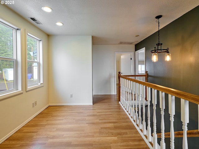 23860 S Beavercreek Rd, Beavercreek, OR 97004 - corridor with light wood finished floors, a chandelier, recessed lighting, and an upstairs landing
