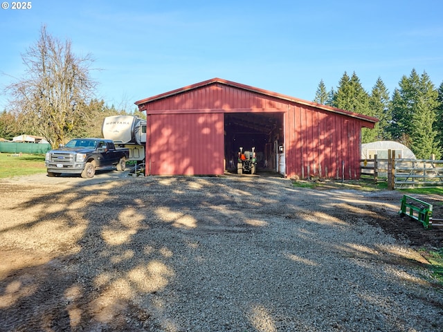 view of pole building featuring fence