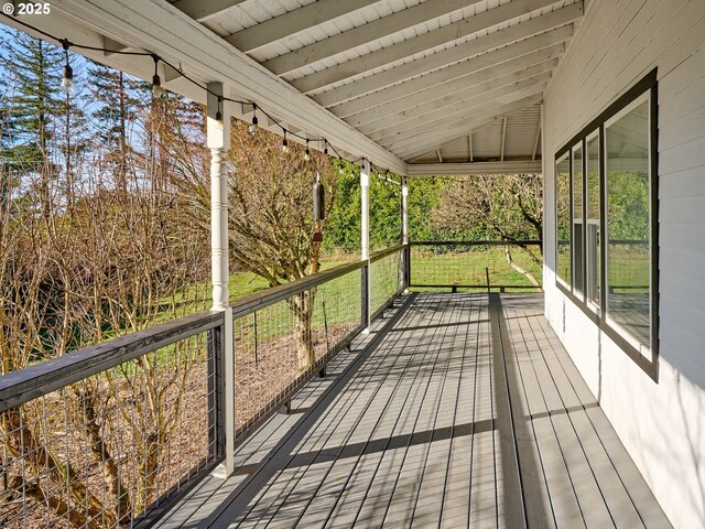 view of front of property featuring a porch, fence, and metal roof