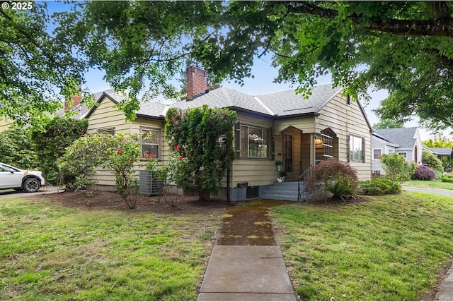 1937 SE Knight St, Portland, OR 97202 - view of front of home with a front lawn, a shingled roof, a chimney, and central air condition unit