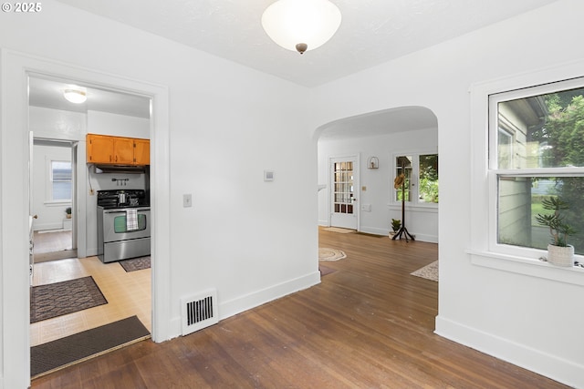 1937 SE Knight St, Portland, OR 97202 - hallway with arched walkways, baseboards, and light wood-type flooring