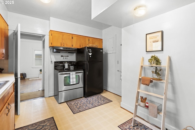 1937 SE Knight St, Portland, OR 97202 - kitchen featuring electric stove, under cabinet range hood, freestanding refrigerator, light floors, and light countertops