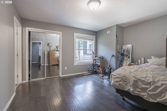 11364 James Way Dr SE, Aumsville, OR 97325 - bedroom with a textured ceiling, wood finished floors, baseboards, and a closet