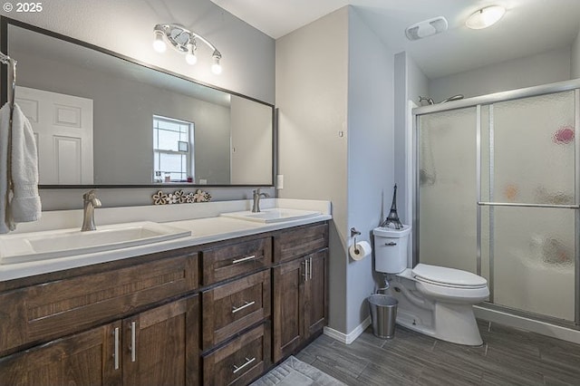 11364 James Way Dr SE, Aumsville, OR 97325 - bathroom with toilet, double vanity, a stall shower, and wood finished floors