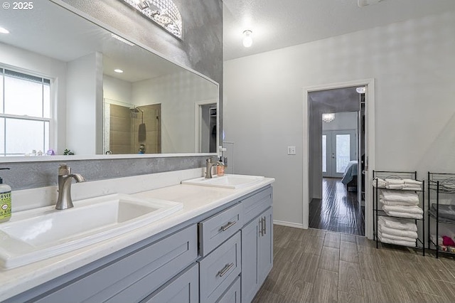 11364 James Way Dr SE, Aumsville, OR 97325 - ensuite bathroom featuring healthy amount of natural light, double vanity, a tile shower, and wood finished floors