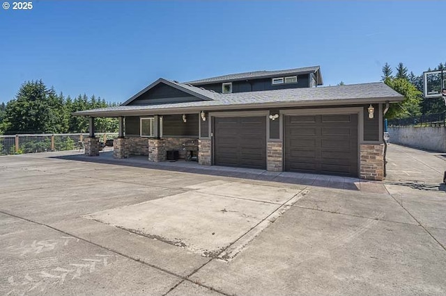 11364 James Way Dr SE, Aumsville, OR 97325 - view of front of house featuring stone siding, an attached garage, and driveway