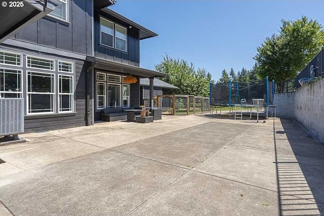 11364 James Way Dr SE, Aumsville, OR 97325 - fenced backyard featuring a trampoline, a patio area, and central AC