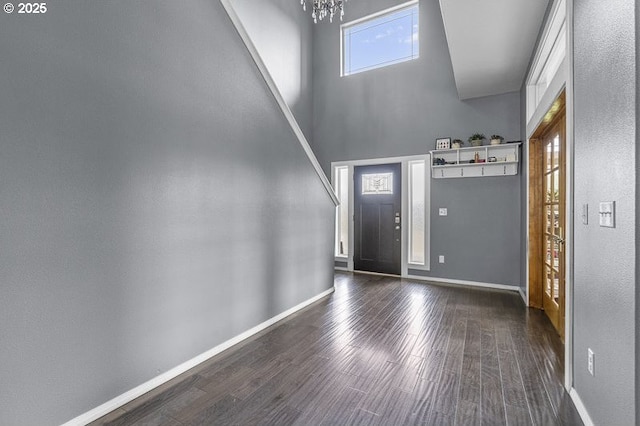11364 James Way Dr SE, Aumsville, OR 97325 - foyer entrance featuring dark wood-style floors, a towering ceiling, a chandelier, and baseboards
