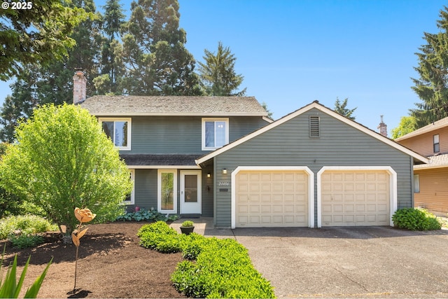 21456 SW 90th Ct, Tualatin, OR 97062 - traditional-style home with a garage, a chimney, and asphalt driveway