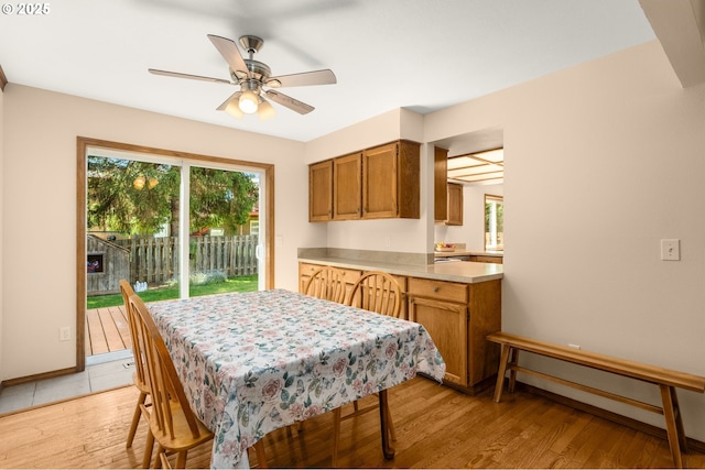 21456 SW 90th Ct, Tualatin, OR 97062 - dining space with healthy amount of natural light, a ceiling fan, light wood-style floors, and baseboards