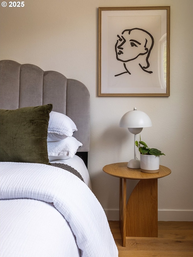 bedroom featuring baseboards and wood finished floors