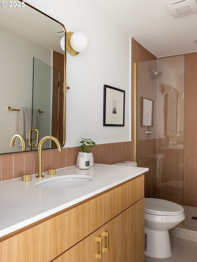 full bath with vanity, a stall shower, and toilet
