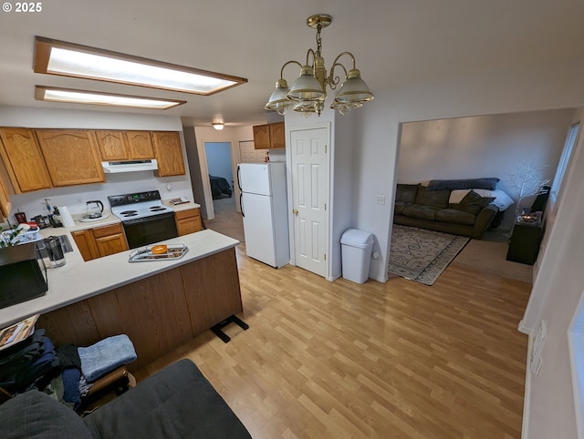 kitchen with electric range oven, light countertops, freestanding refrigerator, open floor plan, and range hood