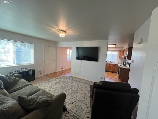living room featuring baseboards and visible vents