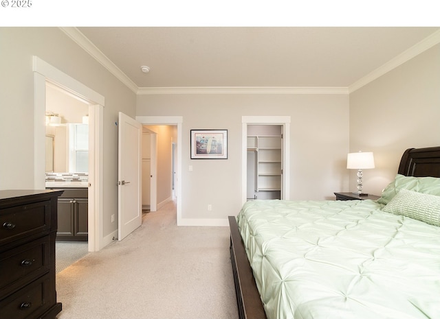 bedroom featuring light carpet, baseboards, ornamental molding, a closet, and a walk in closet