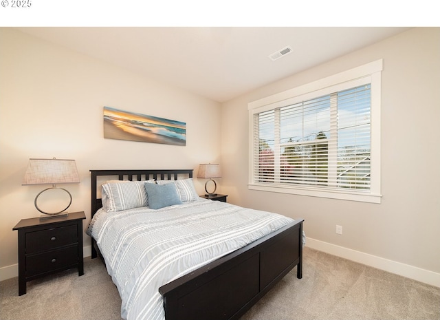 carpeted bedroom with baseboards and visible vents