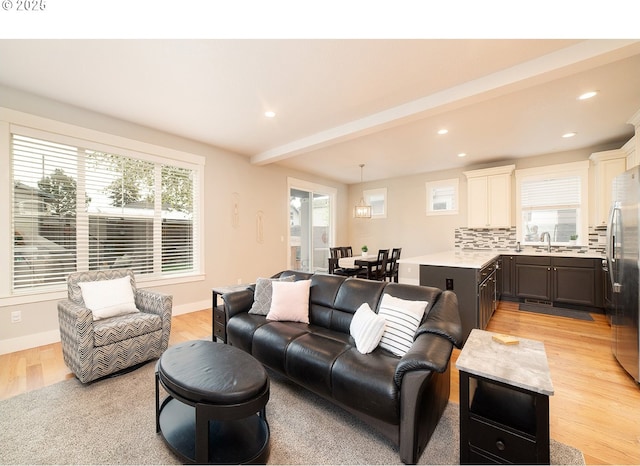 living area featuring recessed lighting, light wood-style floors, and baseboards