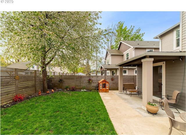 view of yard with a fenced backyard and a patio