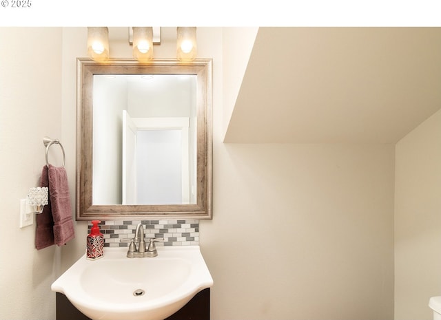 half bathroom featuring decorative backsplash and a sink