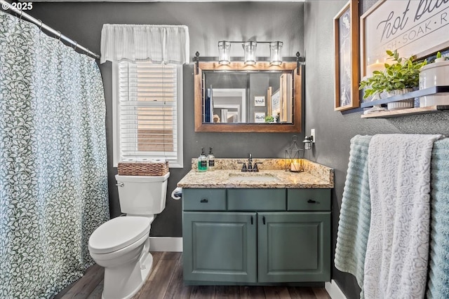 bathroom featuring vanity, hardwood / wood-style floors, curtained shower, and toilet