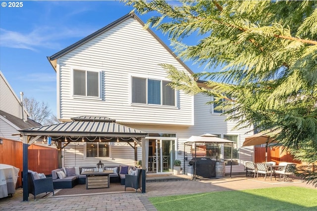 back of property with a gazebo, an outdoor hangout area, and a patio area