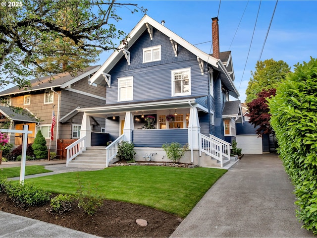 3136 NE 41st Ave, Portland, OR 97212 - american foursquare style home with a chimney, a porch, an outdoor structure, a detached garage, and a front lawn