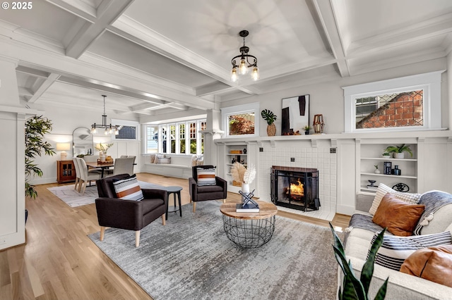 3136 NE 41st Ave, Portland, OR 97212 - living room with a chandelier, coffered ceiling, a tile fireplace, light wood-style flooring, and beamed ceiling