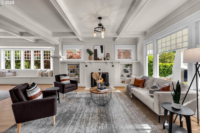 3136 NE 41st Ave, Portland, OR 97212 - living area with a lit fireplace, beam ceiling, coffered ceiling, wood finished floors, and crown molding