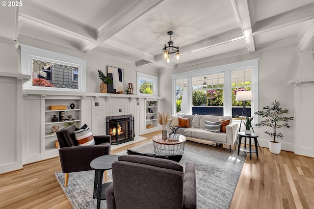 3136 NE 41st Ave, Portland, OR 97212 - living area featuring a tiled fireplace, coffered ceiling, beamed ceiling, light wood-type flooring, and baseboards