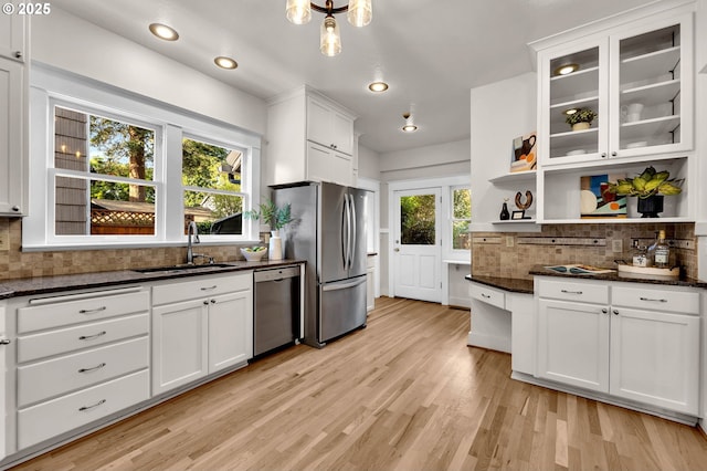 3136 NE 41st Ave, Portland, OR 97212 - kitchen with stainless steel appliances, open shelves, a sink, decorative backsplash, and light wood-style floors