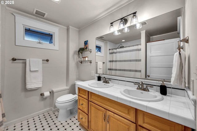 3136 NE 41st Ave, Portland, OR 97212 - full bathroom featuring double vanity, toilet, baseboards, ornamental molding, and tile patterned floors