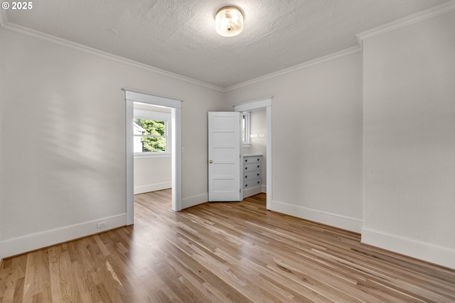 3136 NE 41st Ave, Portland, OR 97212 - empty room featuring light wood-style floors, baseboards, ornamental molding, and a textured ceiling